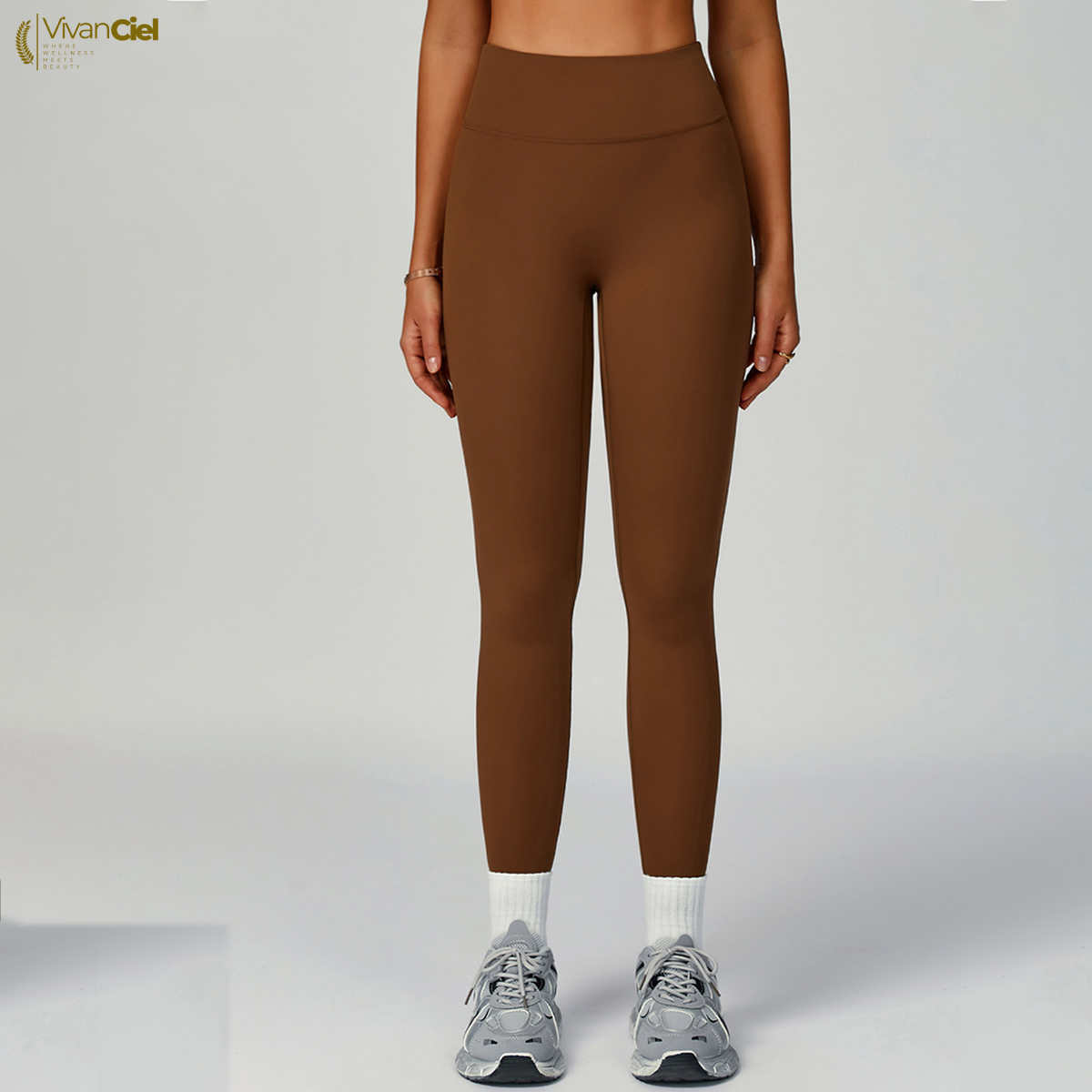 Brown leggings worn by a person on a white background