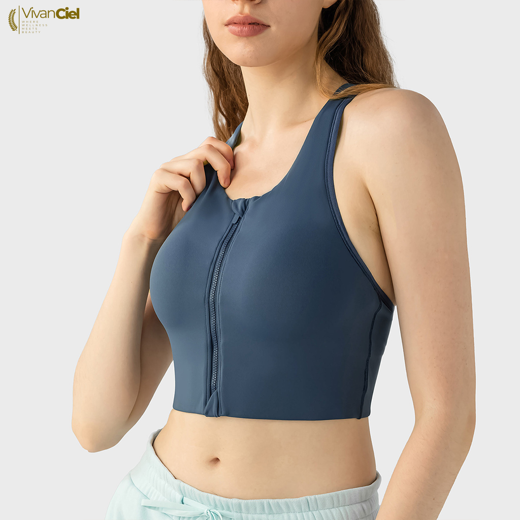 Woman wearing a blue sports bra with a plain background